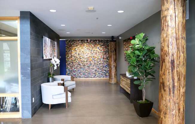 A room with a white couch and a wooden pillar.