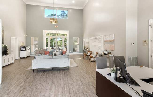 a living room with a couch and a table and a computer at Lagniappe of Biloxi Apartment Homes, Biloxi, Mississippi