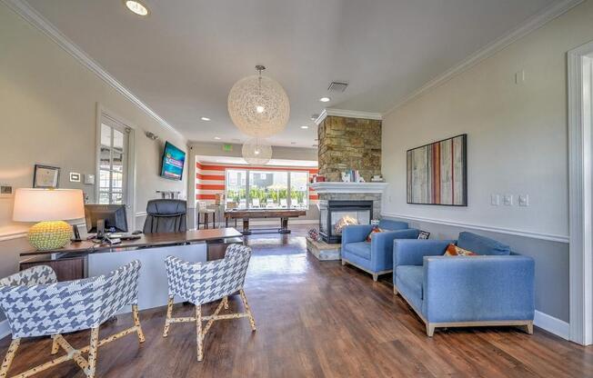 a living room with blue couches and chairs and a fireplace