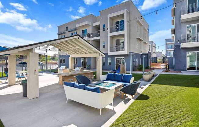 A modern outdoor seating area with a table and chairs is set up in front of a building.