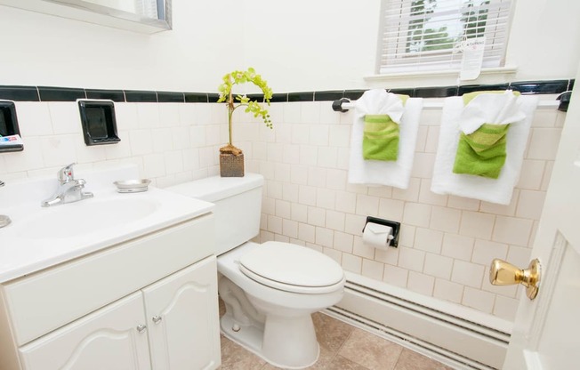 Bathroom with white vanity and towels at Mount Ridge Apartments, Baltimore MD