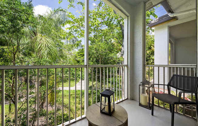 a balcony with a view of a yard and trees