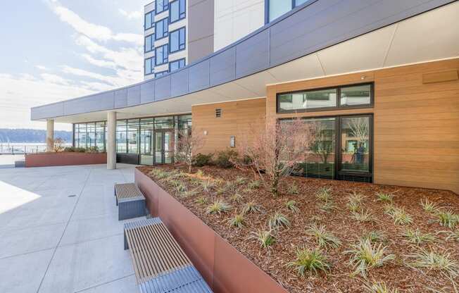 a courtyard with benches and plants next to a building at Marina Square, WA 98337