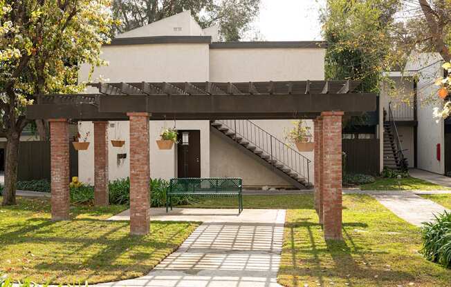 A small building with a staircase leading to the front door.