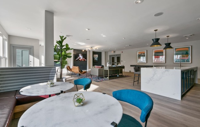 a living room with blue chairs and a white table