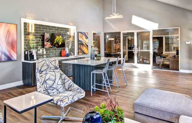 A modern living room with a wooden floor and a grey sofa.