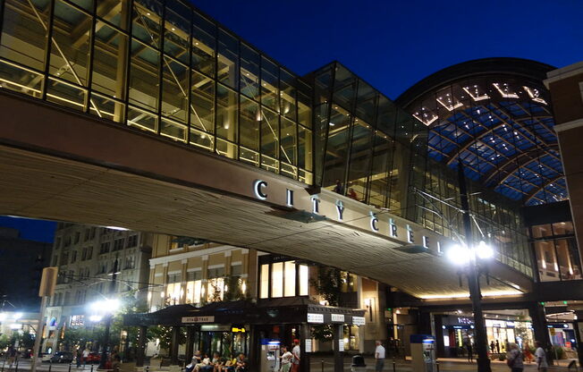 a view of the exterior of the city center mall at night