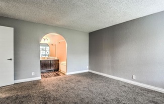 A room with a carpeted floor and a white door.