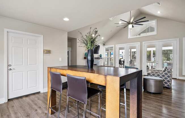 A modern kitchen with a wooden island and bar stools.