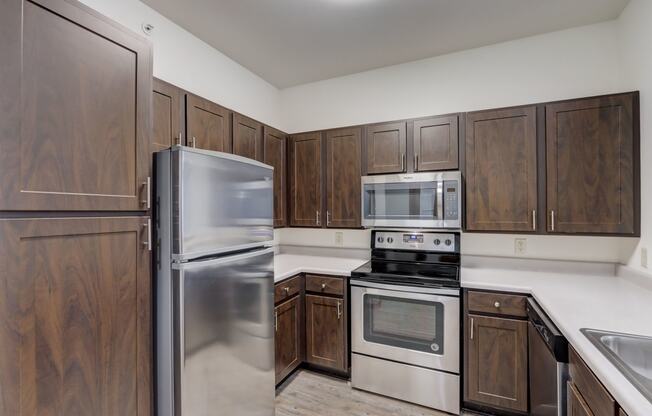 a kitchen with stainless steel appliances and wooden cabinets