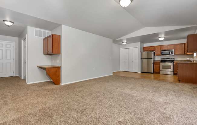A kitchen area with a refrigerator, microwave, and oven.