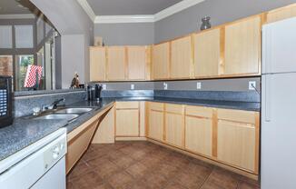 a large kitchen with stainless steel appliances and wooden cabinets