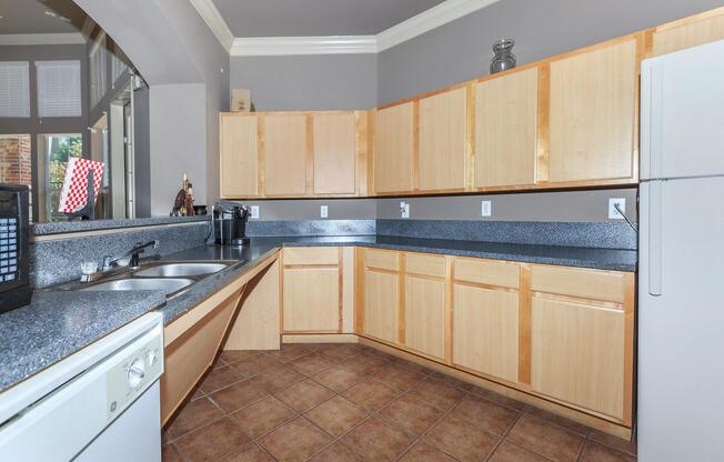 a large kitchen with stainless steel appliances and wooden cabinets