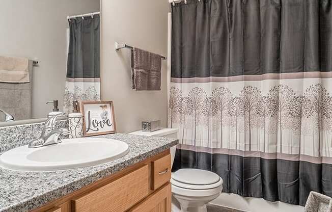 Bathroom with granite countertop and lots of lighting at Skyline View Apartments in Lincoln NE