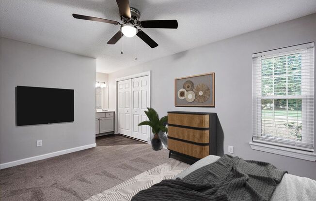 a bedroom with a bed and a ceiling fan
