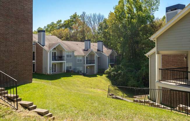 Large Grass Area with Sloping Hill Between Pelican Cove Apartment Buildings