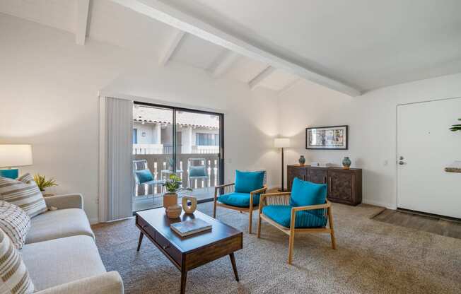 a living room with a couch chairs and a coffee table