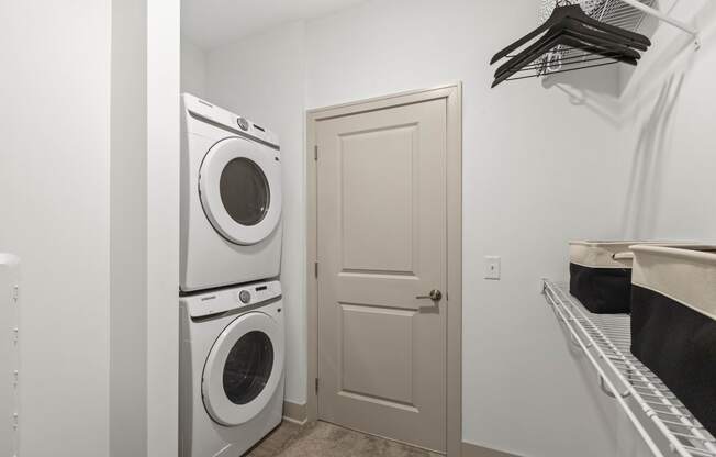 a washer and dryer in a laundry room with a white door