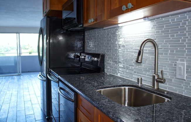 Napili Towers kitchen area with appliances, cabinets, and counters