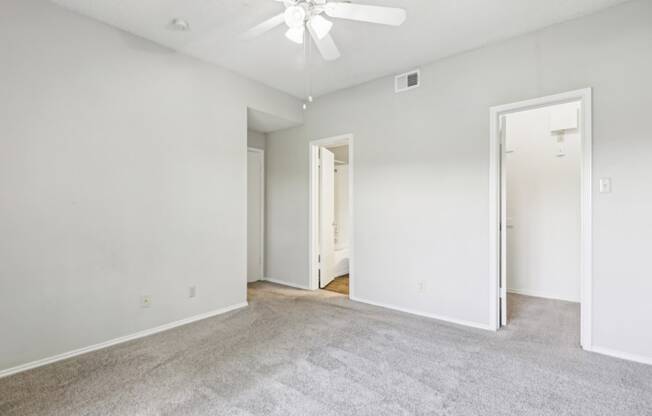 Second bedroom of B1 floor plan with walk-in closet and private bathroom at Jefferson Creek Apartments in Irving, TX.