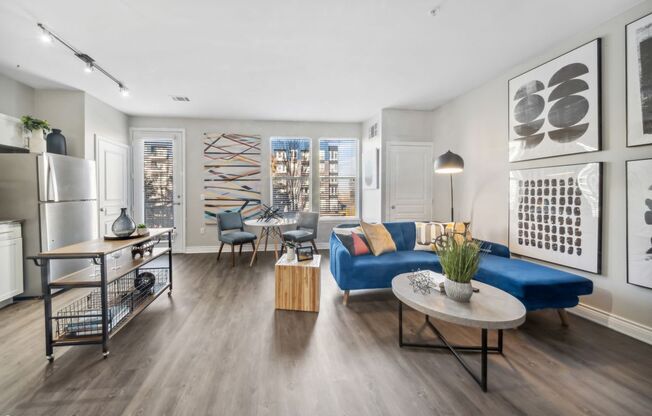 A modern living room with a blue couch and a coffee table.