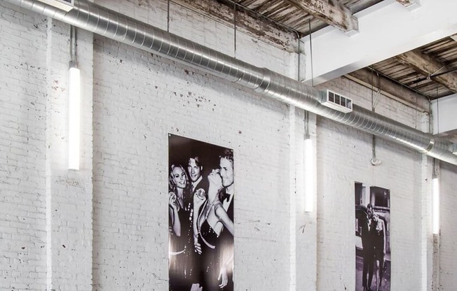 a black and white photo of the beatles on a brick wall