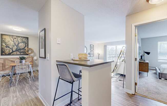 a living room with a bar and a dining room