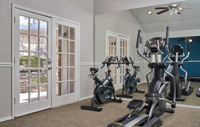 Uncover a fitness haven at Distinction Apartment Homes, featuring a spacious gym filled with modern equipment and ample natural light. Elevate your lifestyle and enhance your wellness journey. Schedule a tour today!