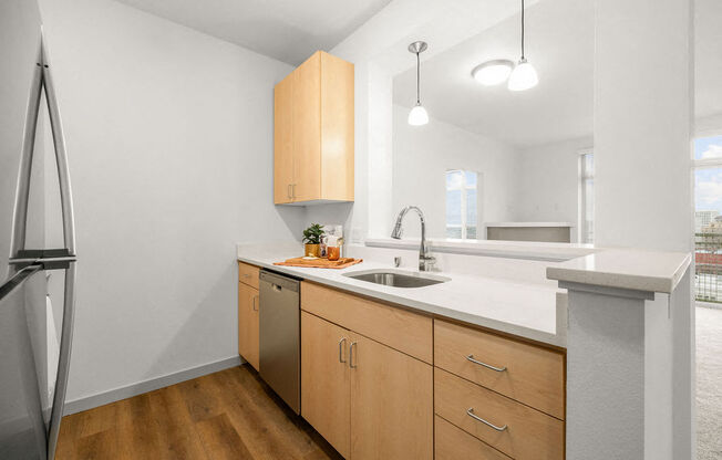 A kitchen with wooden cabinets and a white countertop.