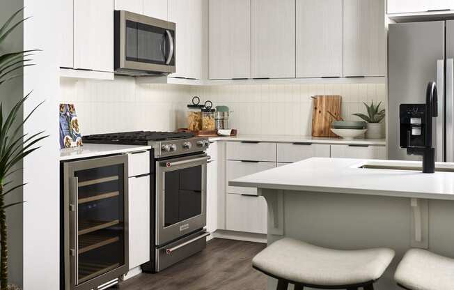 a kitchen with stainless steel appliances and white cabinets