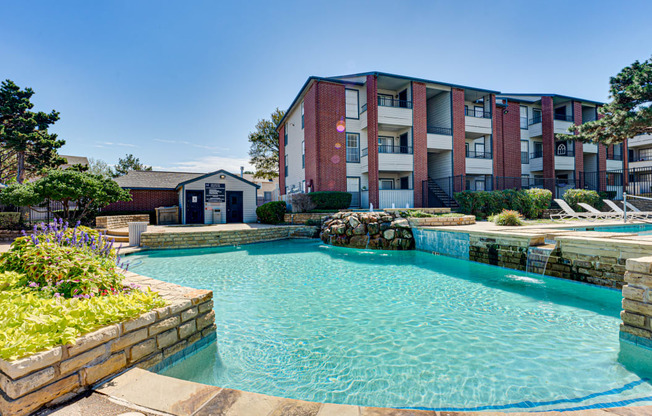 a swimming pool with an apartment building in the background