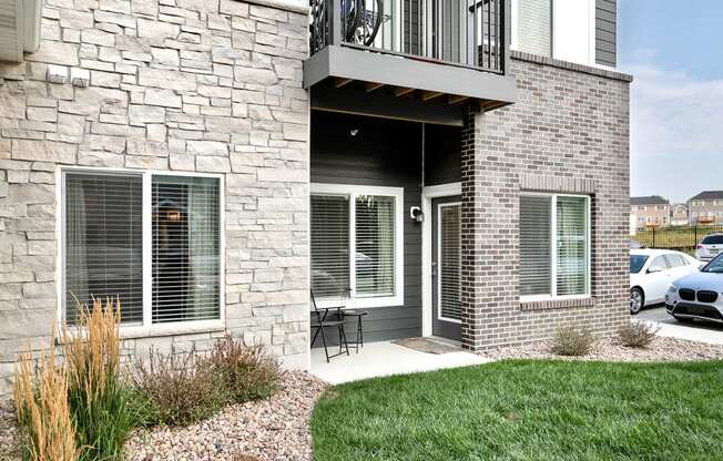 a patio with a table and chairs outside of a house