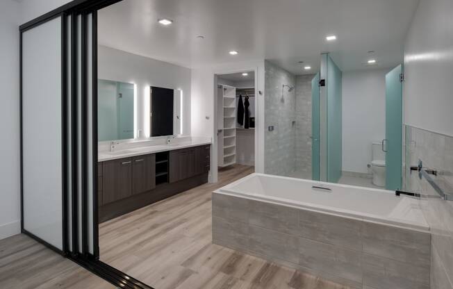 a large bathroom with a large tub and a shower and a sink