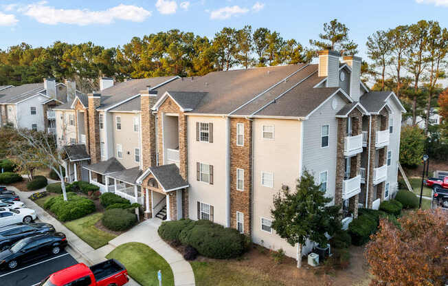 an aerial view of an apartment building with a parking lot