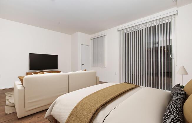 a bedroom with a bed and a chair in a room