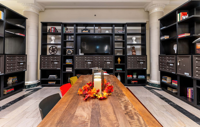 a living room with a large wooden table and a television