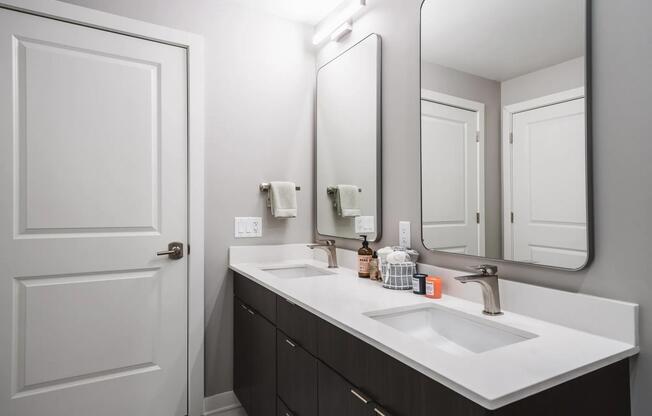 Designer bathrooms with double vanities and quartz countertops
