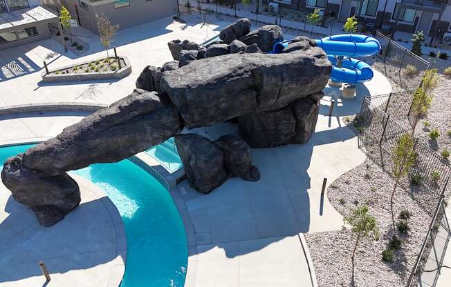 A large rock formation is in the middle of a swimming pool.