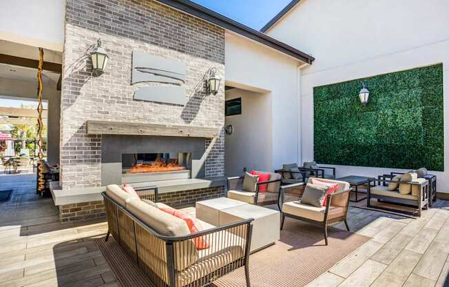 A patio with a fireplace and seating area.