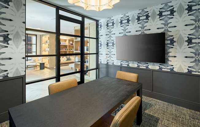 A modern dining room with a large table and chairs.