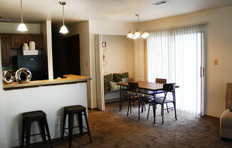 a view of a living room and dining room in a 555 waverly unit
