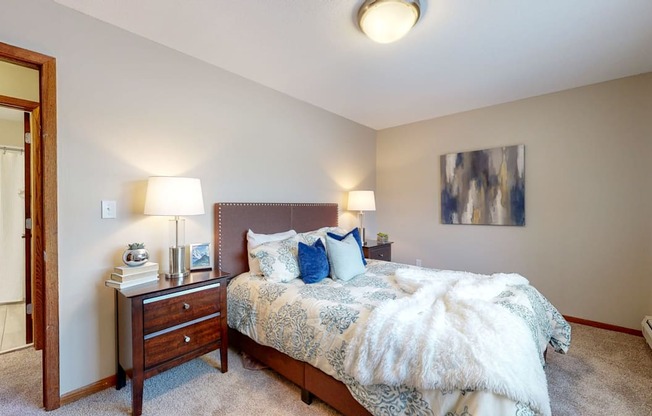 a bedroom with a bed and two night stands