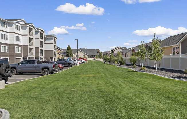 a green lawn in front of a row of houses