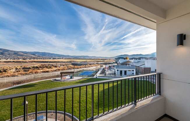a balcony with a view of a building and a pool