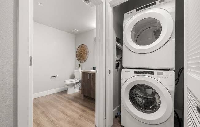 a bathroom with a washer and dryer combo in a 555 waverly unit