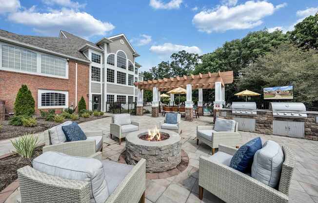 A patio with a fire pit and seating area.