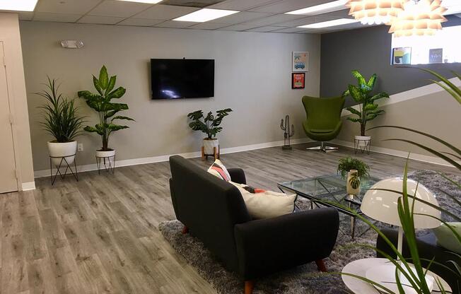 a living room filled with furniture and a flat screen tv