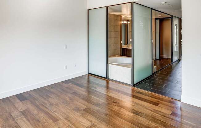 A room with a wooden floor and a glass door.