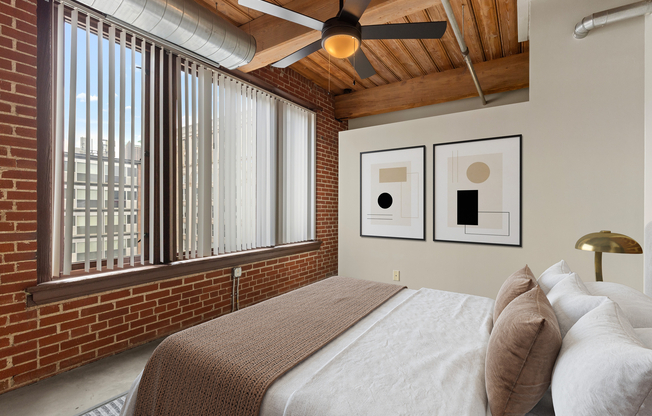 Chic urban bedroom with exposed brick walls