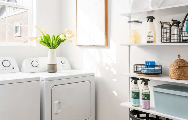 a small laundry room with a washing machine and a window